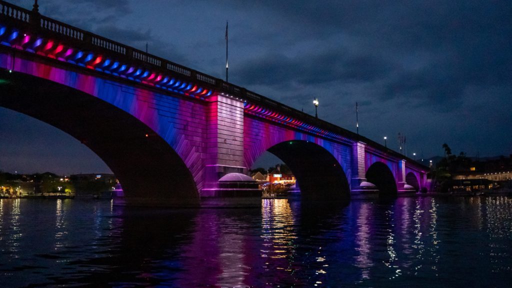 a bridge lit up with red white blue and purple led lights